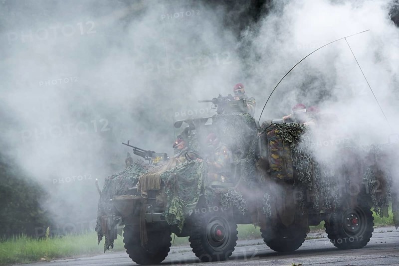 Smoke curtain and Belgian paracommandos of the Para-Commando Regiment under attack in camouflaged LRPV armoured vehicle