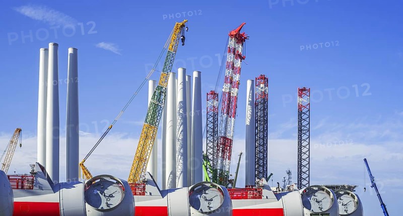 Wind turbine nacelles with rotor hubs and tower sections for offshore SeaMade wind farm at REBO heavy load terminal in Ostend port