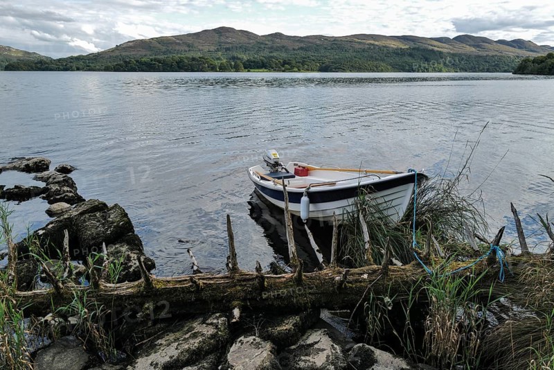 A motor boat tied up on the shores of Lough Gill at evening time. Sligo