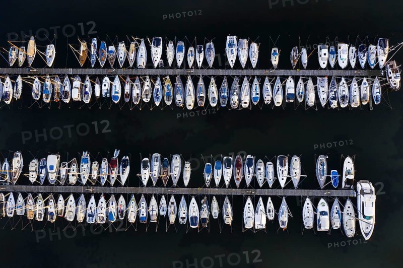 Aerial view over jetties with sailing boats at marina in harbour of Heiligenhafen along the Baltic Sea