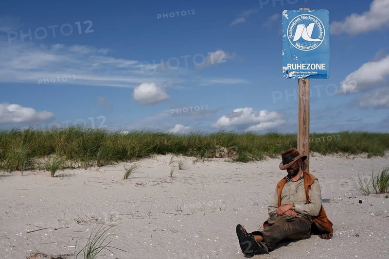 Bird warden resting at a National Park sign