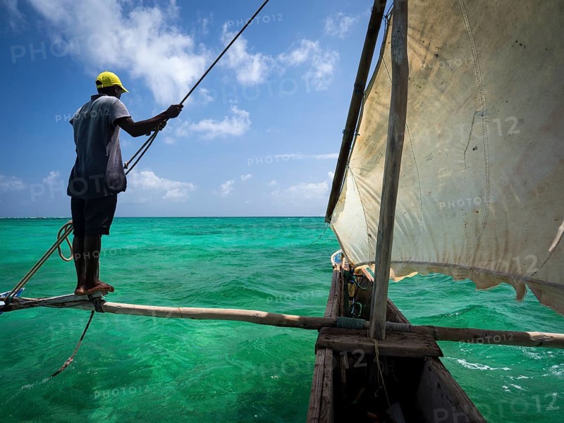 Local man steering outrigger boat