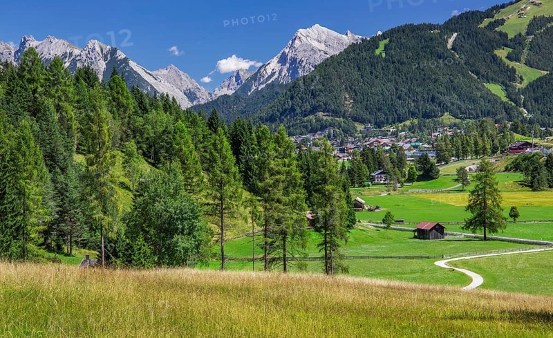 Landscape on the high plateau with a view of the village and the northern Karwendel mountain range
