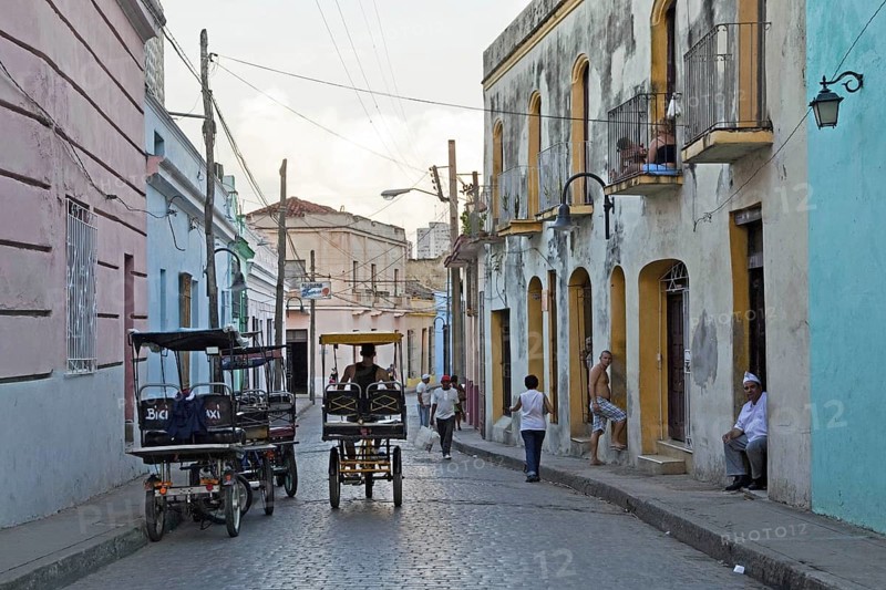 Street scene showing three-wheeled bicycle taxis in the city Camagueey