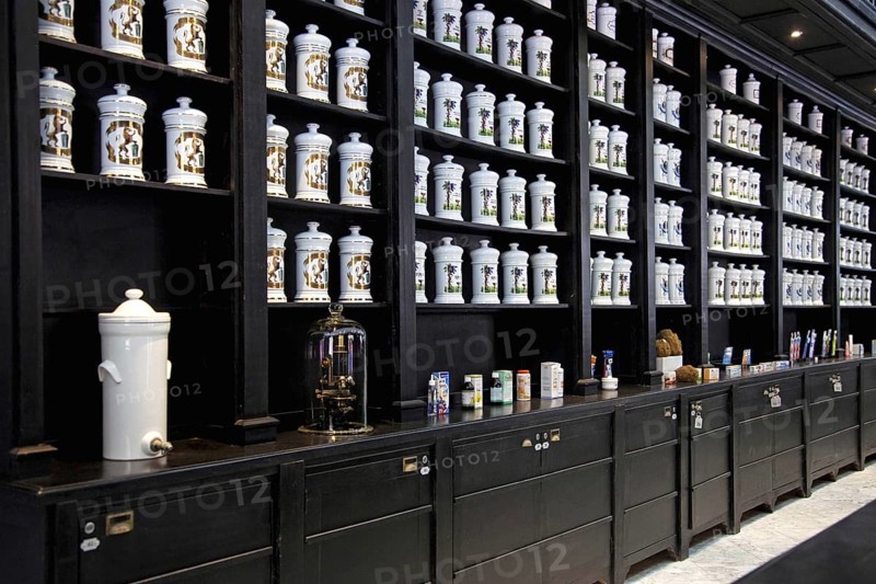 Porcelain jars with medicines and herbs in old pharmacy cabinet of drugstore in the Calle Obispo