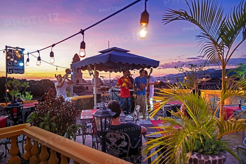 Cuban band at sunset with musicians playing salsa music at rooftop bar in the city Trinidad