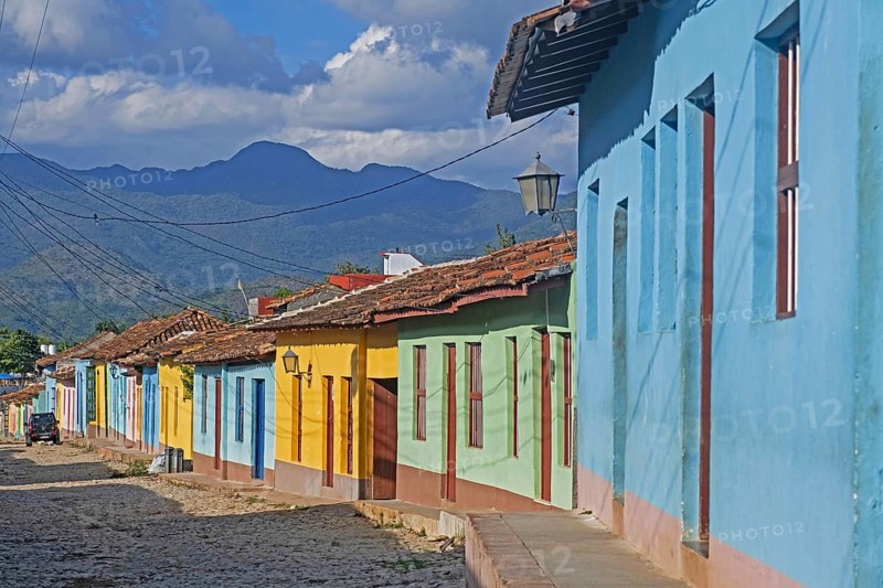 Colonial cobbled street with pastel coloured houses in the city Trinidad