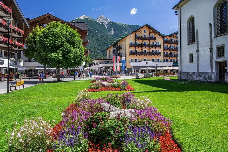 Flower border on the village square with hotels