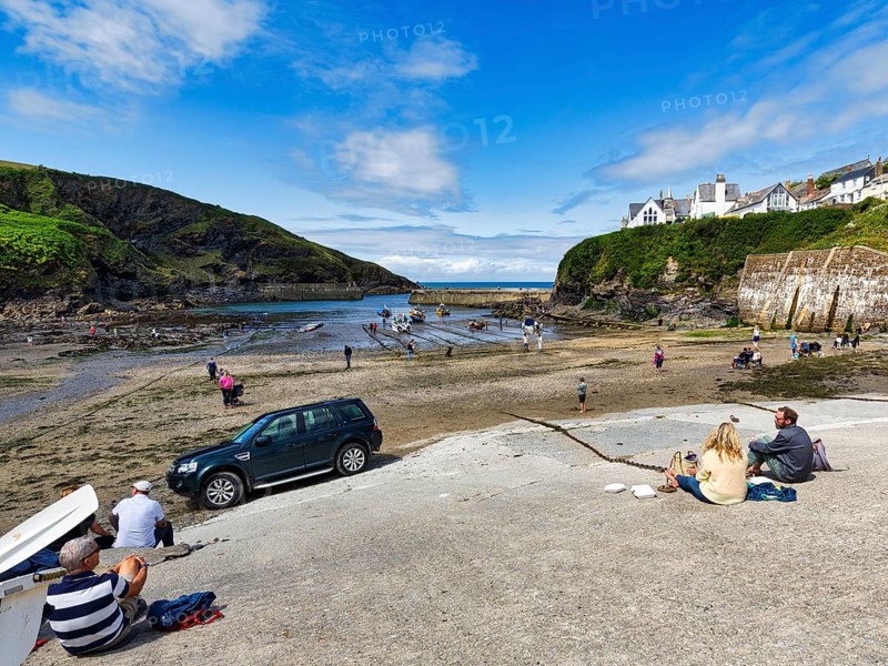 Pedestrians in the harbour at low tide