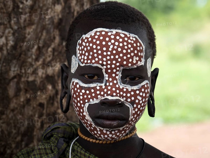 Girl from the Mursi tribe with face painting