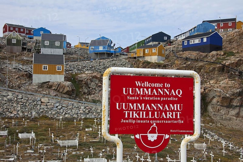 Uummannaq village with colourful houses and welcome sign of Santa's vacation paradise