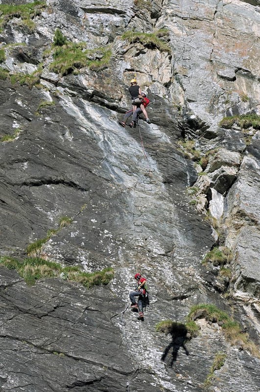 Swiss rescue helicopter winching rescuer and climber