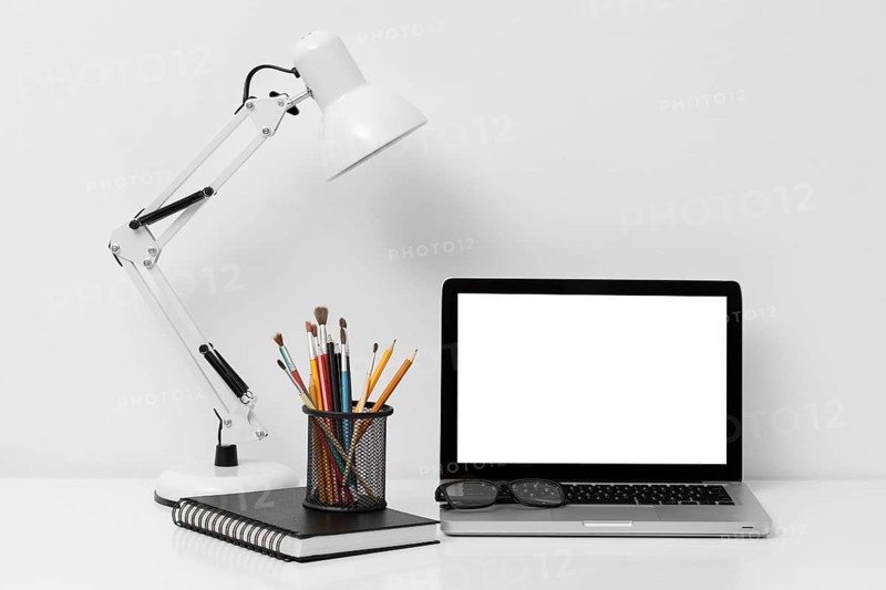 Front view arrangement office elements with laptop