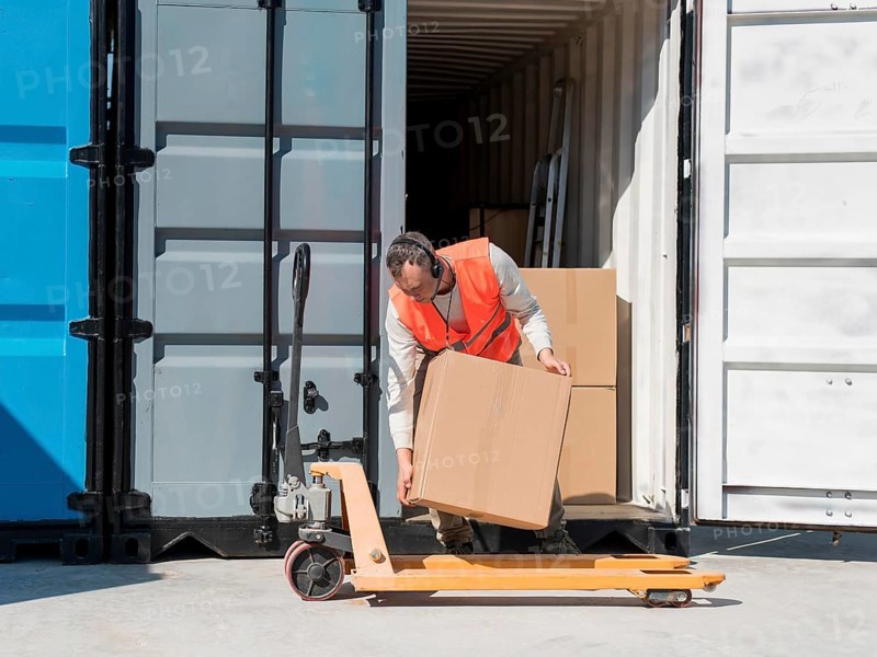 Full shot man carrying box