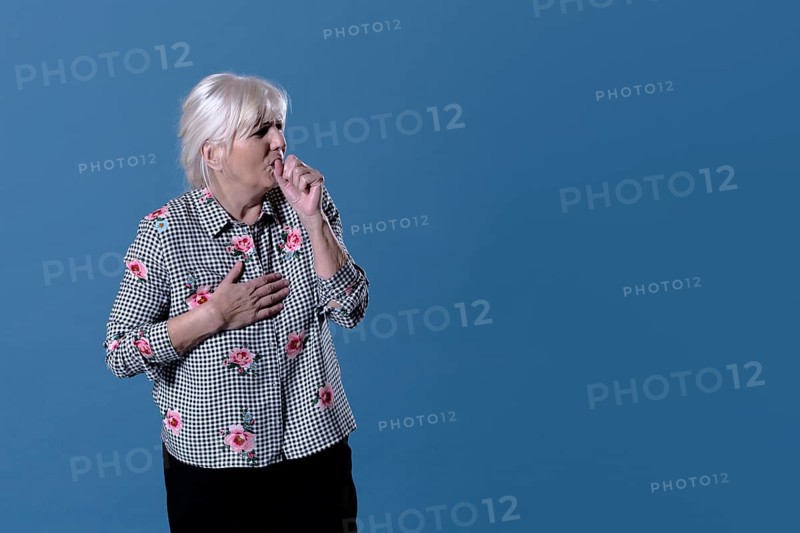 Elderly woman is coughing