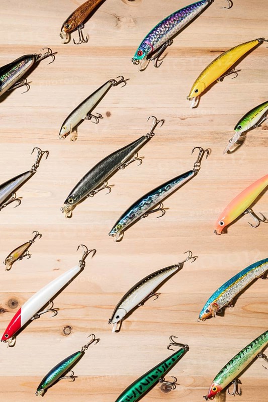 Diagonal colorful fishing lures wooden surface