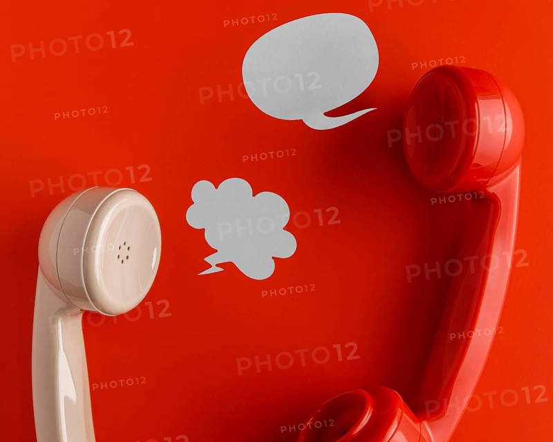 Top view telephone receivers with chat bubbles