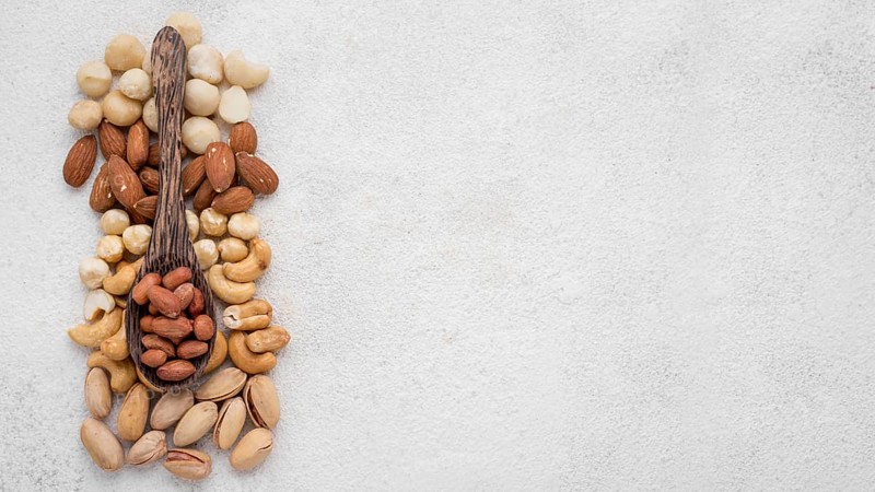 Different kinds nuts spoon copy space