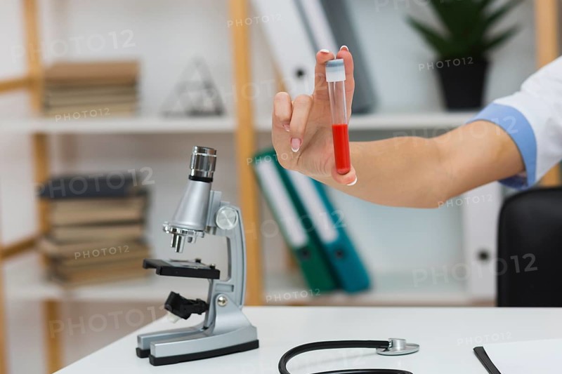 Female doctor hand holding blood sample