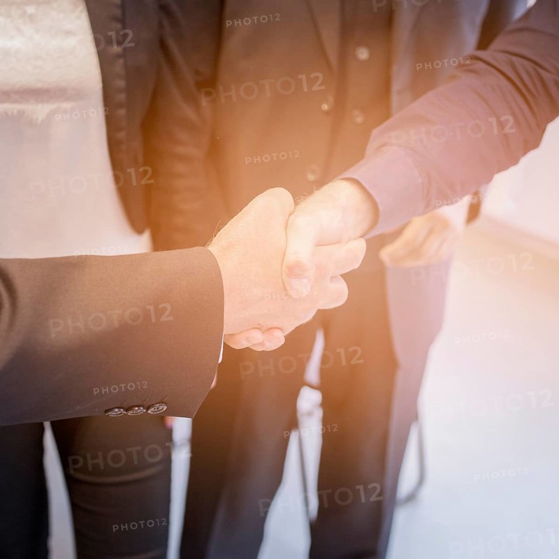 Overhead view two businessman shaking hands together