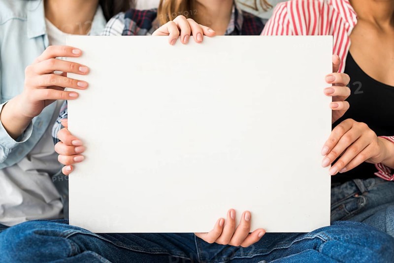 Big white sheet paper holding by women