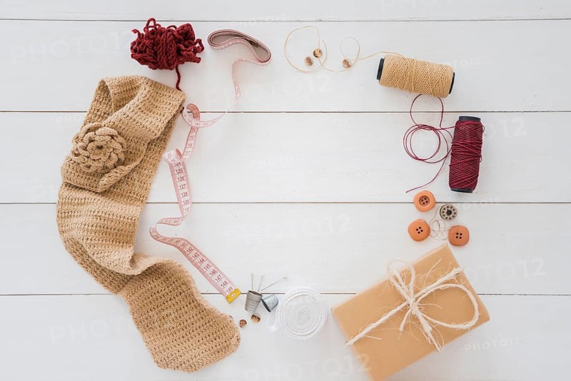Knitted hosiery wool measuring tape spool button wrapped gift box wooden desk