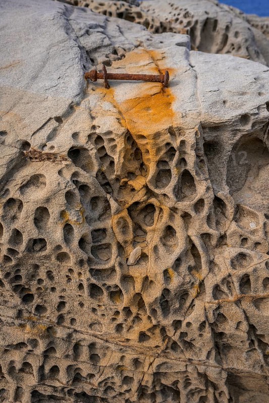 Rusty screw and stone structures in the Buca delle Fate