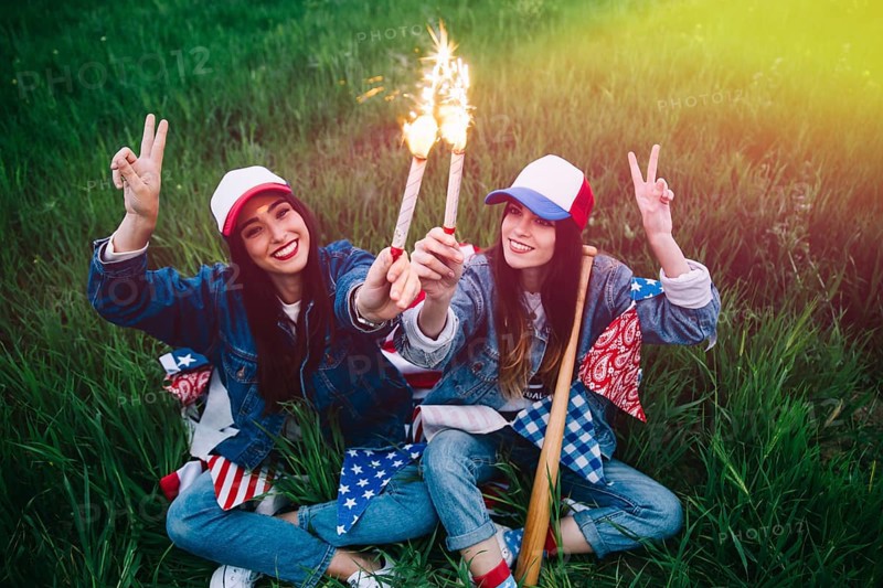 Women with fireworks hands smiling