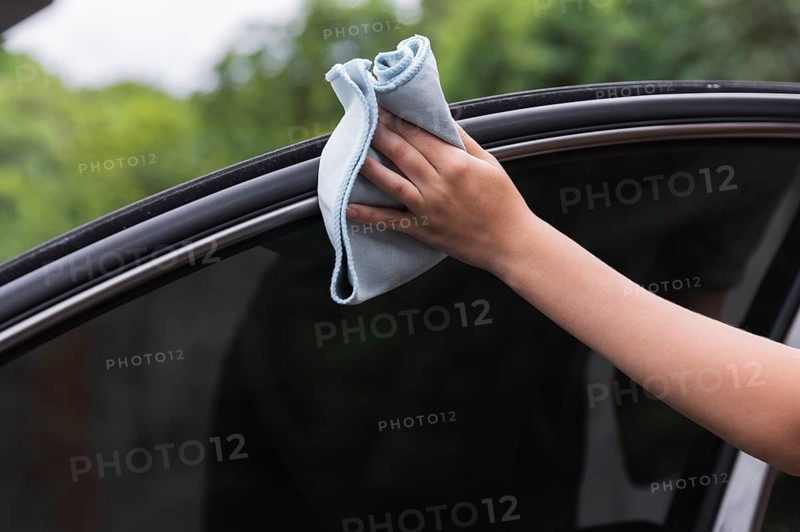 Close up shot hand cleaning car door