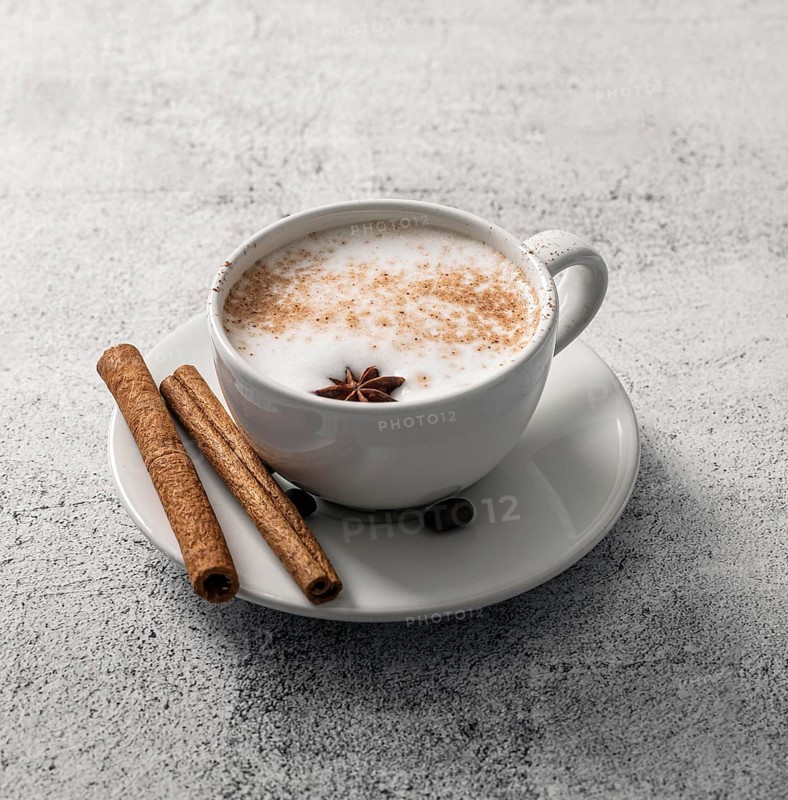 High angle coffee cup with cinnamon sticks star anise