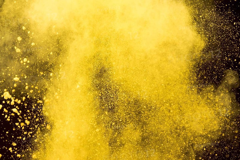 Yellow cloud cosmetic powder black background