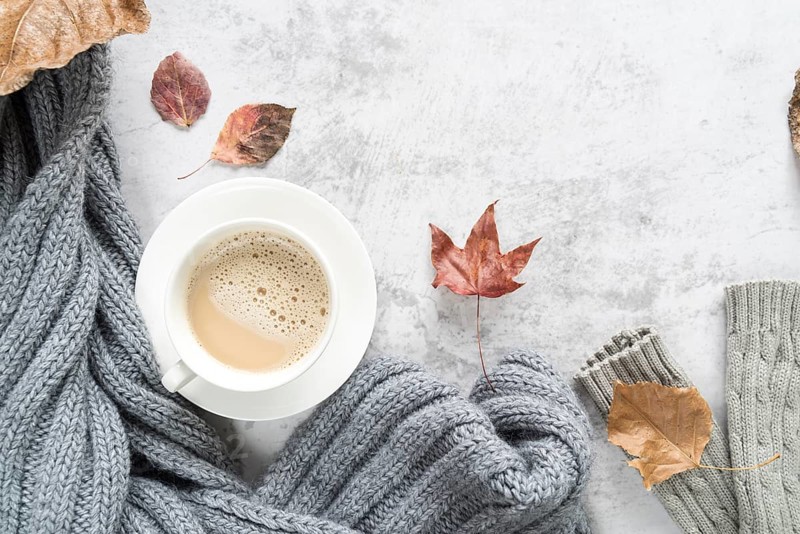Hot beverage with warm sweater light surface