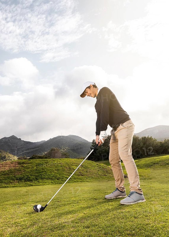 Side view man playing golf field with club copy space