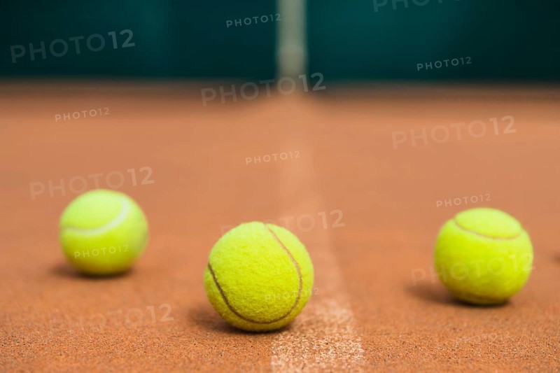 Three green tennis balls tennis court