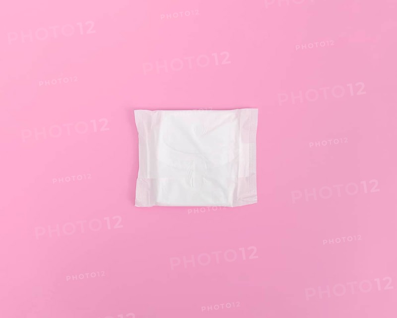 Closed sanitary towel pink background