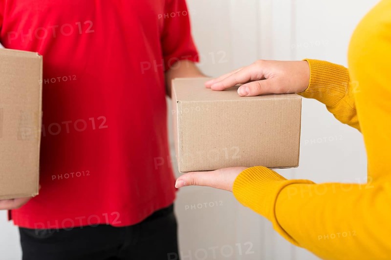 Woman taking package from delivery man