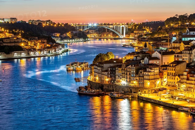 View over the river Douro to the old town of Porto and Vila Nova de Gaia at dusk