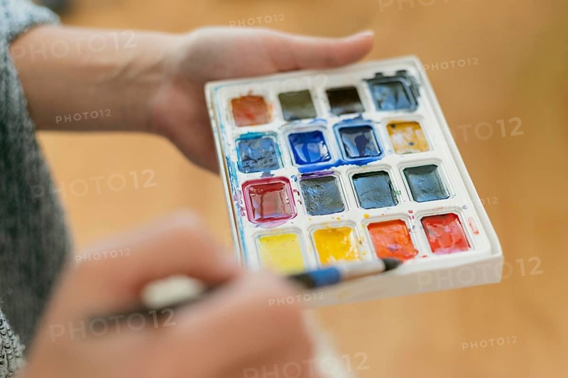 Close up artist holding color palette