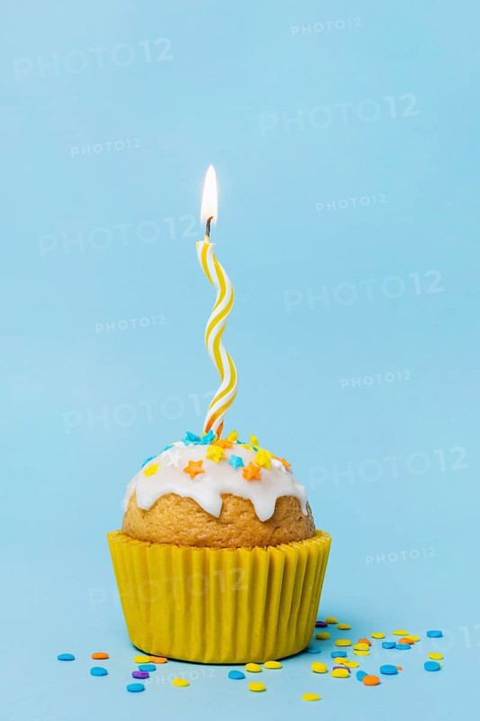 Sweet cupcake with lit candle
