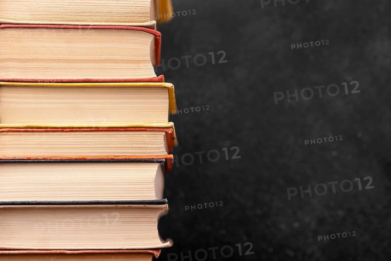 Front view stack different books with copy space