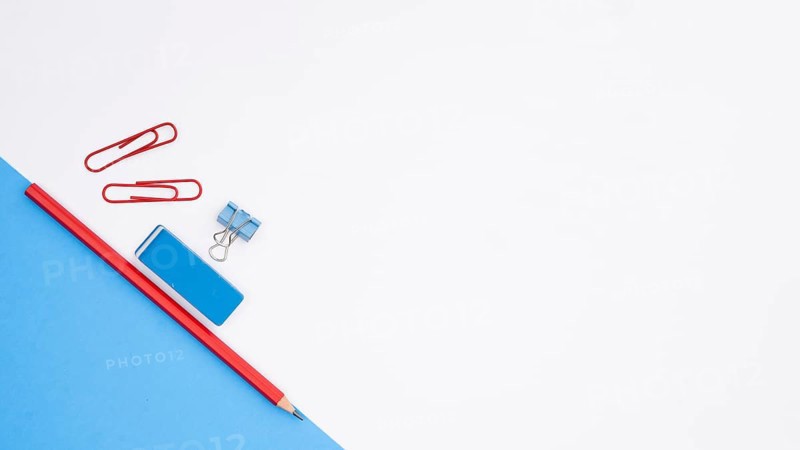 Pencil eraser paper clip with blue card paper white backdrop