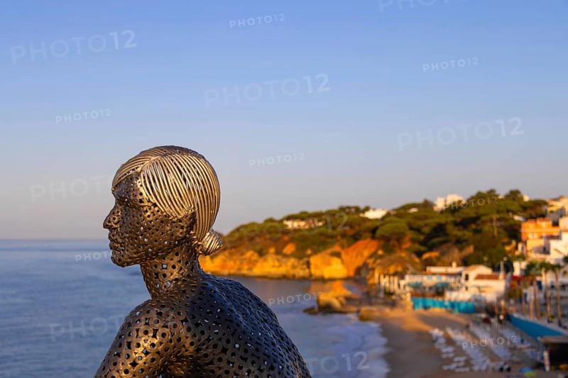 A metal sculpture by artist Carlos de Oliveira Correia looks out over the Atlantic Ocean from the viewing platform on Olhos des Augua beach shortly after sunrise.