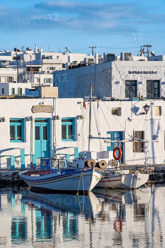 Fishing boats in Naoussa harbour with reflection