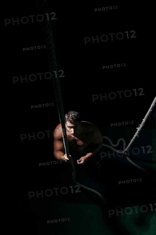 Crossfit concept with man pulling tow