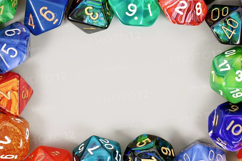 Colorful role playing RPG dice forming border around gray background with copy space