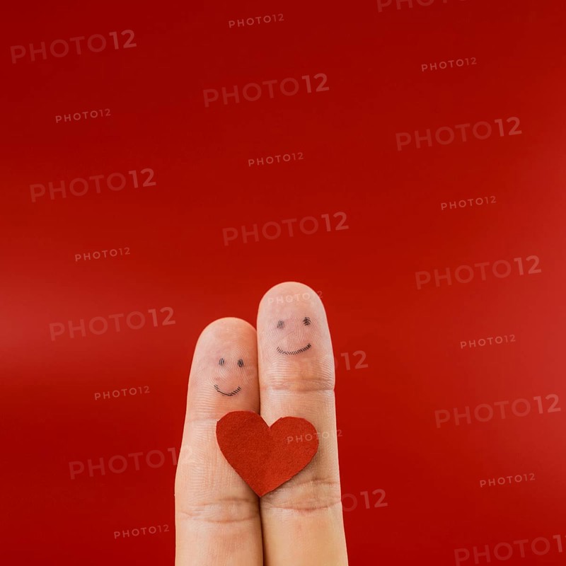 Two fingers painted with happy faces