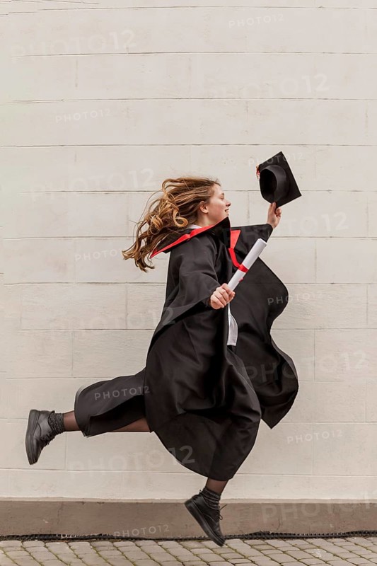 Side view girl jumping graduation