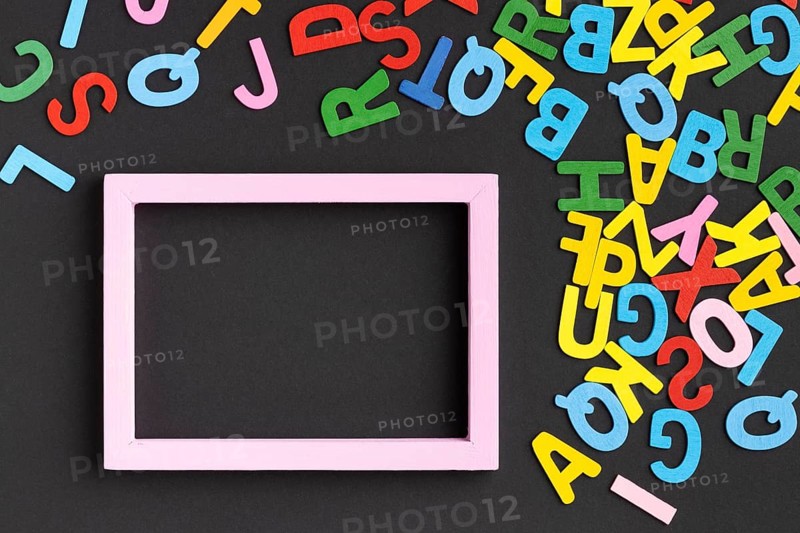 Flat lay frame with colorful letters