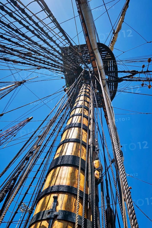 Masts of old wooden Age of sail sailing ship with ropes cordage and shroud and crow's nest
