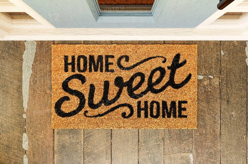 Home sweet home doormat on the porch at the front door